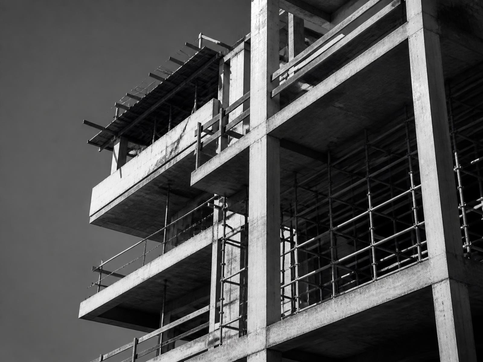 Exposed concrete structural frame of a building under construction