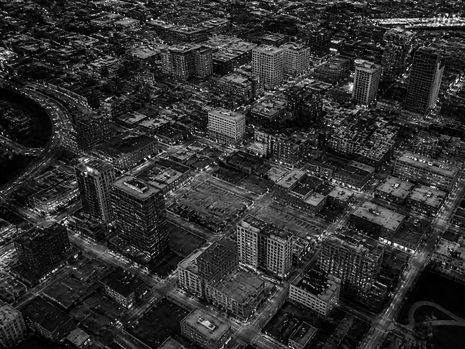 Aerial black-and-white view of a dense urban grid